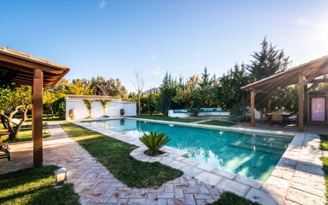 Bar de la piscina a la izquierda y zona de barbacoa a la derecha